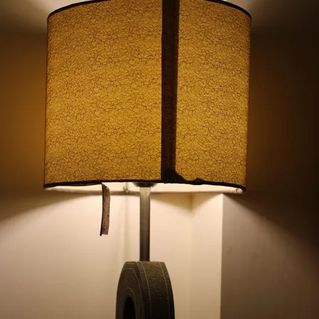 A lit table lamp casts warm light through its textured shade.